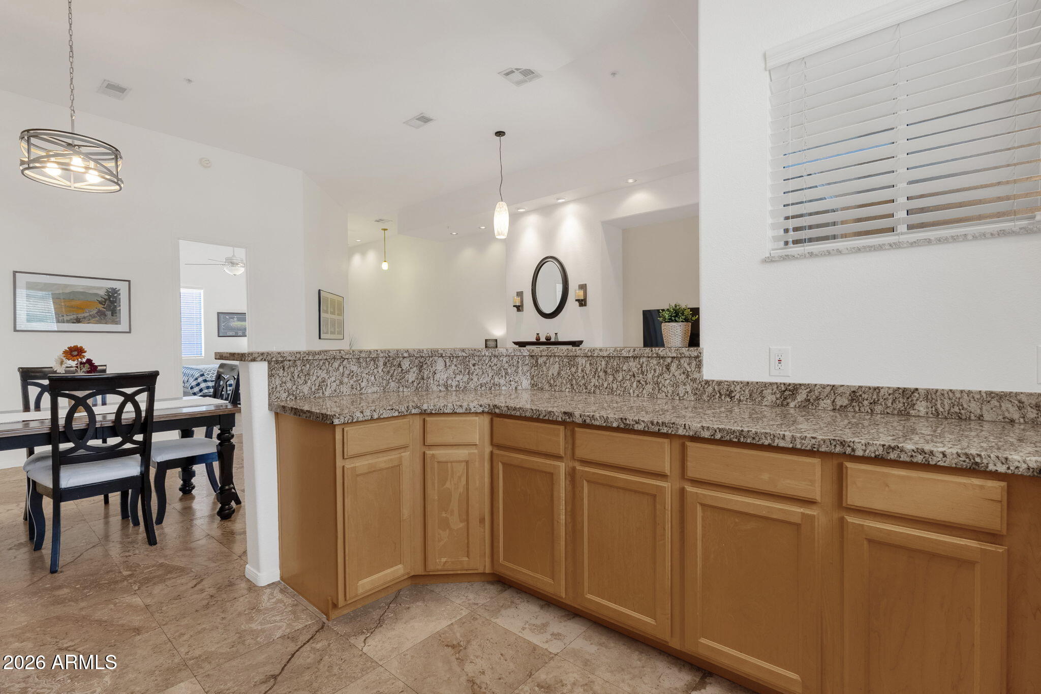 8245 East Bell Road, Unit 208 Scottsdale, AZ 85260 - Photo 28 of 48 a kitchen with granite countertop a sink cabinets and wooden floor