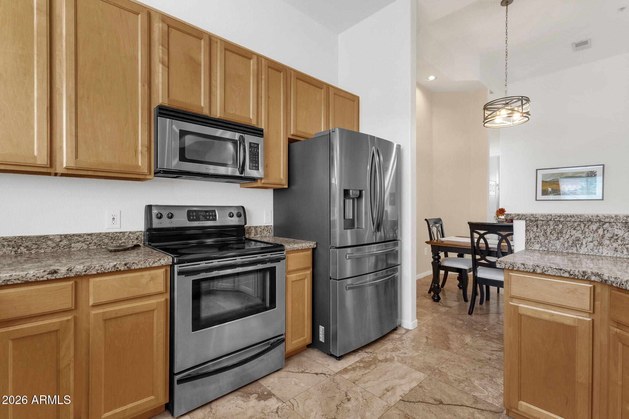 8245 East Bell Road, Unit 208 Scottsdale, AZ 85260 - Photo 29 of 48 a kitchen with stainless steel appliances granite countertop a refrigerator stove a sink and a microwave