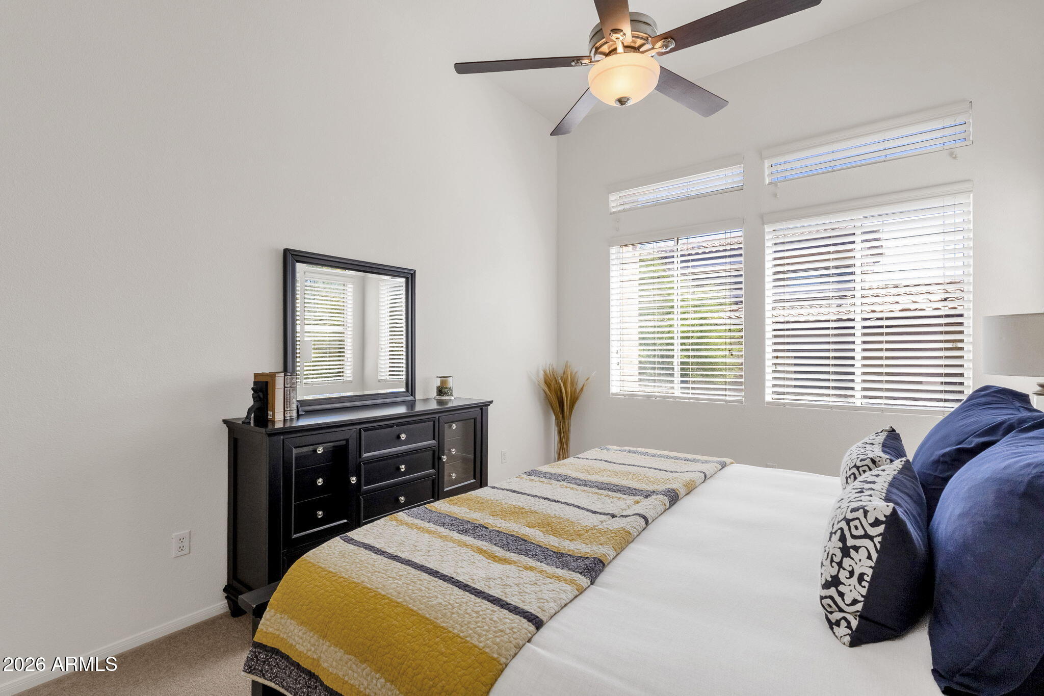 8245 East Bell Road, Unit 208 Scottsdale, AZ 85260 - Photo 30 of 48 a bedroom with a bed and a window