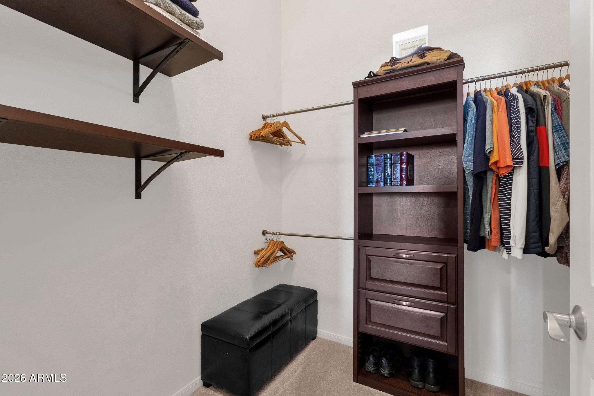 8245 East Bell Road, Unit 208 Scottsdale, AZ 85260 - Photo 34 of 48 a view of walk in closet with clothes and shoes