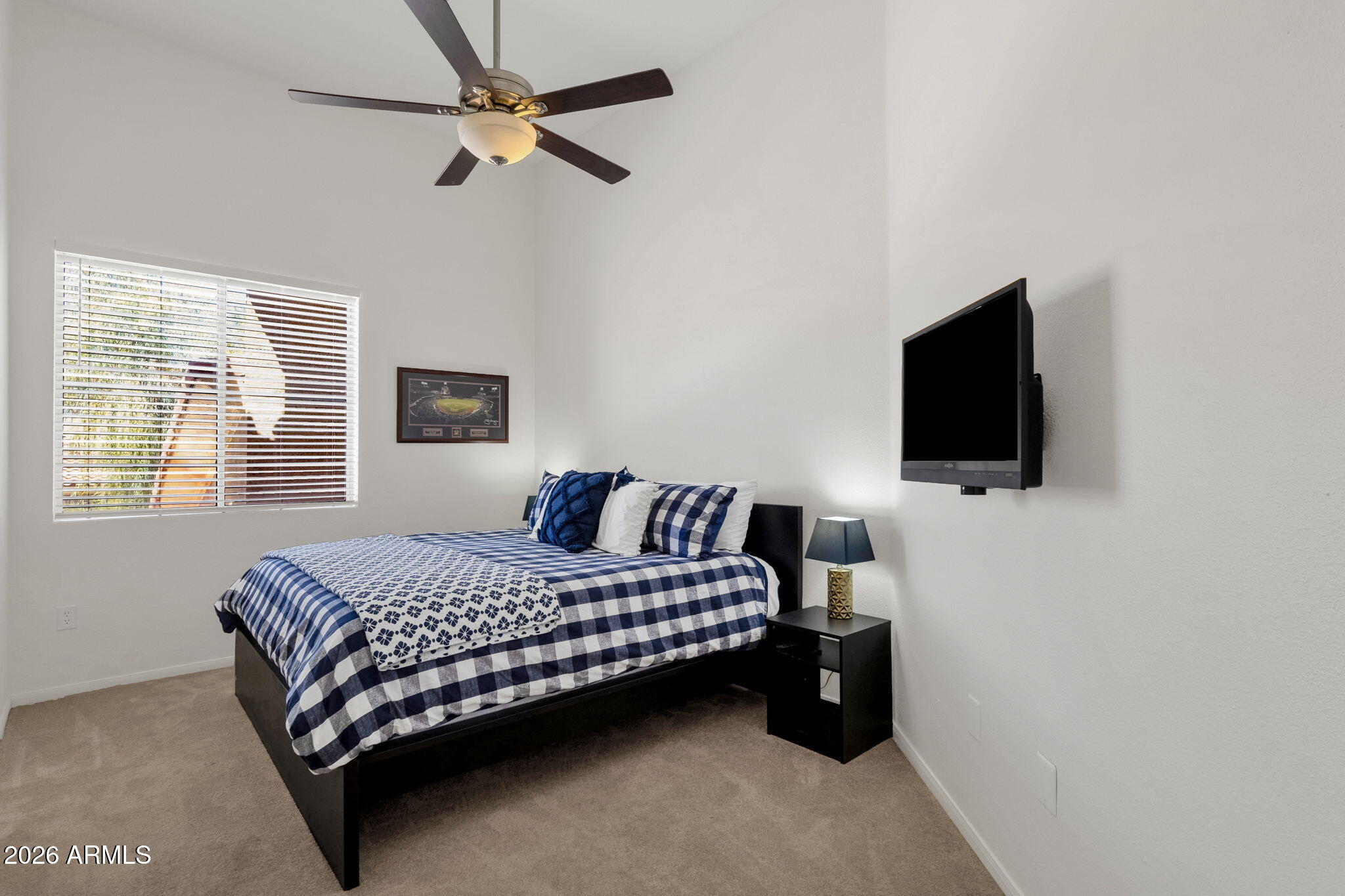 8245 East Bell Road, Unit 208 Scottsdale, AZ 85260 - Photo 35 of 48 a bedroom with a bed tv and a window