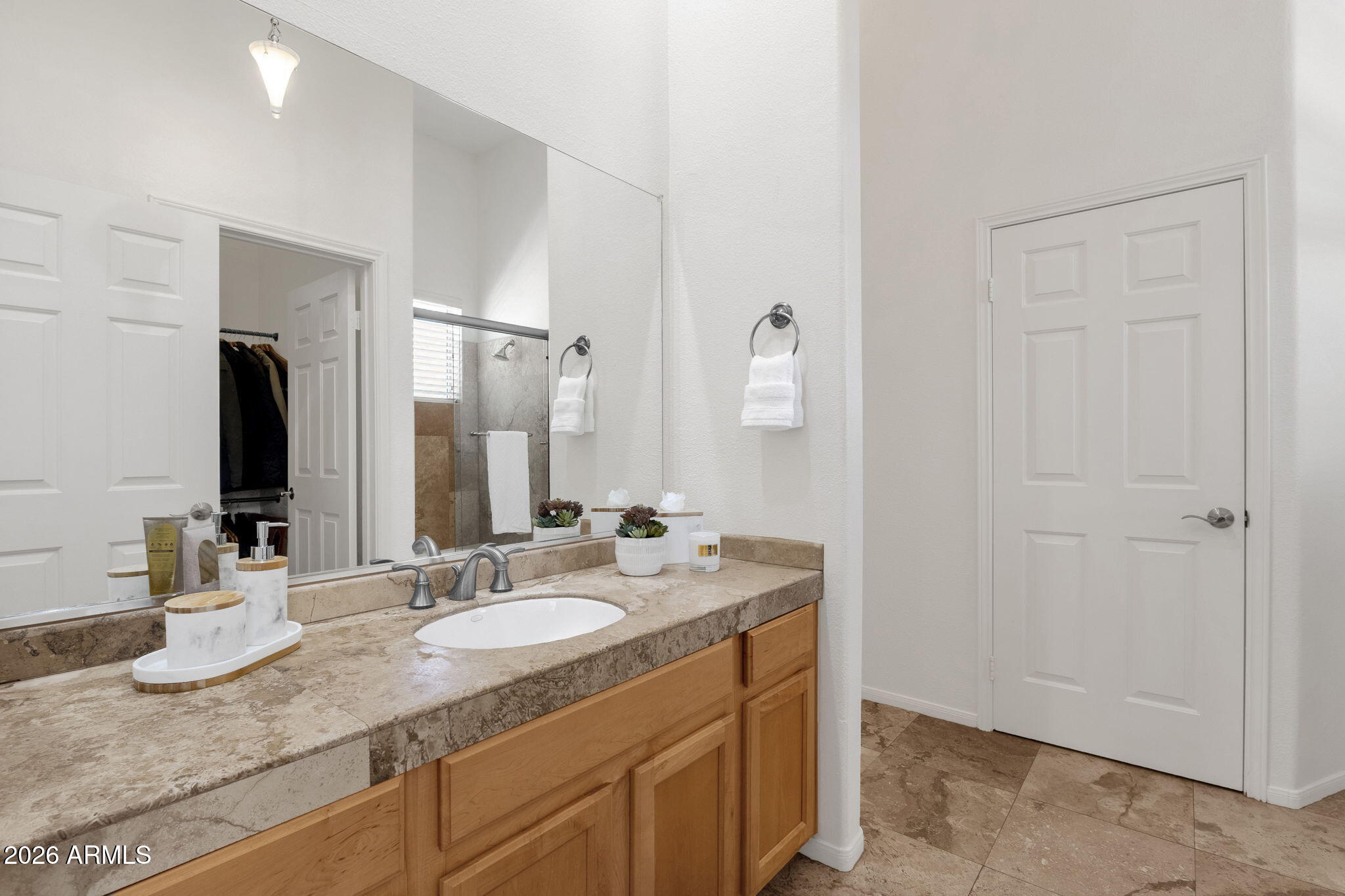 8245 East Bell Road, Unit 208 Scottsdale, AZ 85260 - Photo 37 of 48 a bathroom with a granite countertop sink and a mirror
