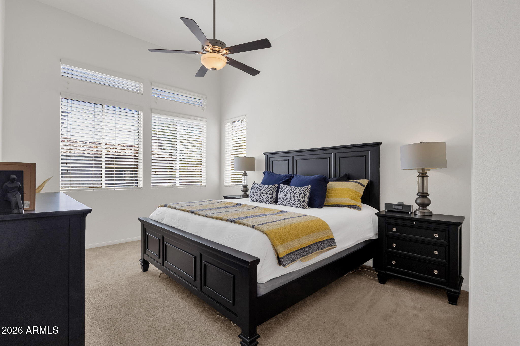 8245 East Bell Road, Unit 208 Scottsdale, AZ 85260 - Photo 5 of 48 a bed room with a bed and a chandelier