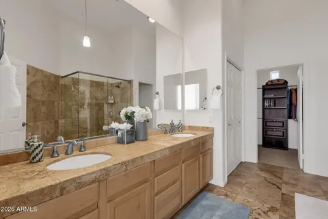 a spacious bathroom with double sink and a mirror