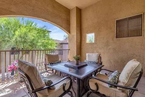 a view of a balcony with furniture
