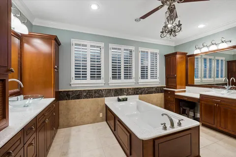 a bathroom with a tub sink and mirror