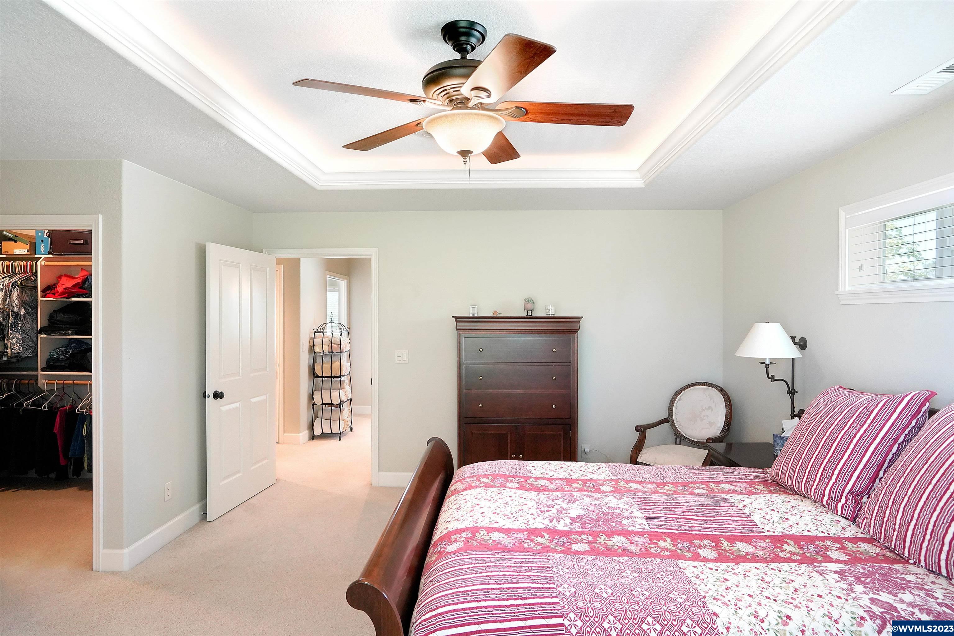 306 Northwest Reed Lane Dallas, OR 97338 - Photo 25 of 42 a bedroom with a bed and a chandelier