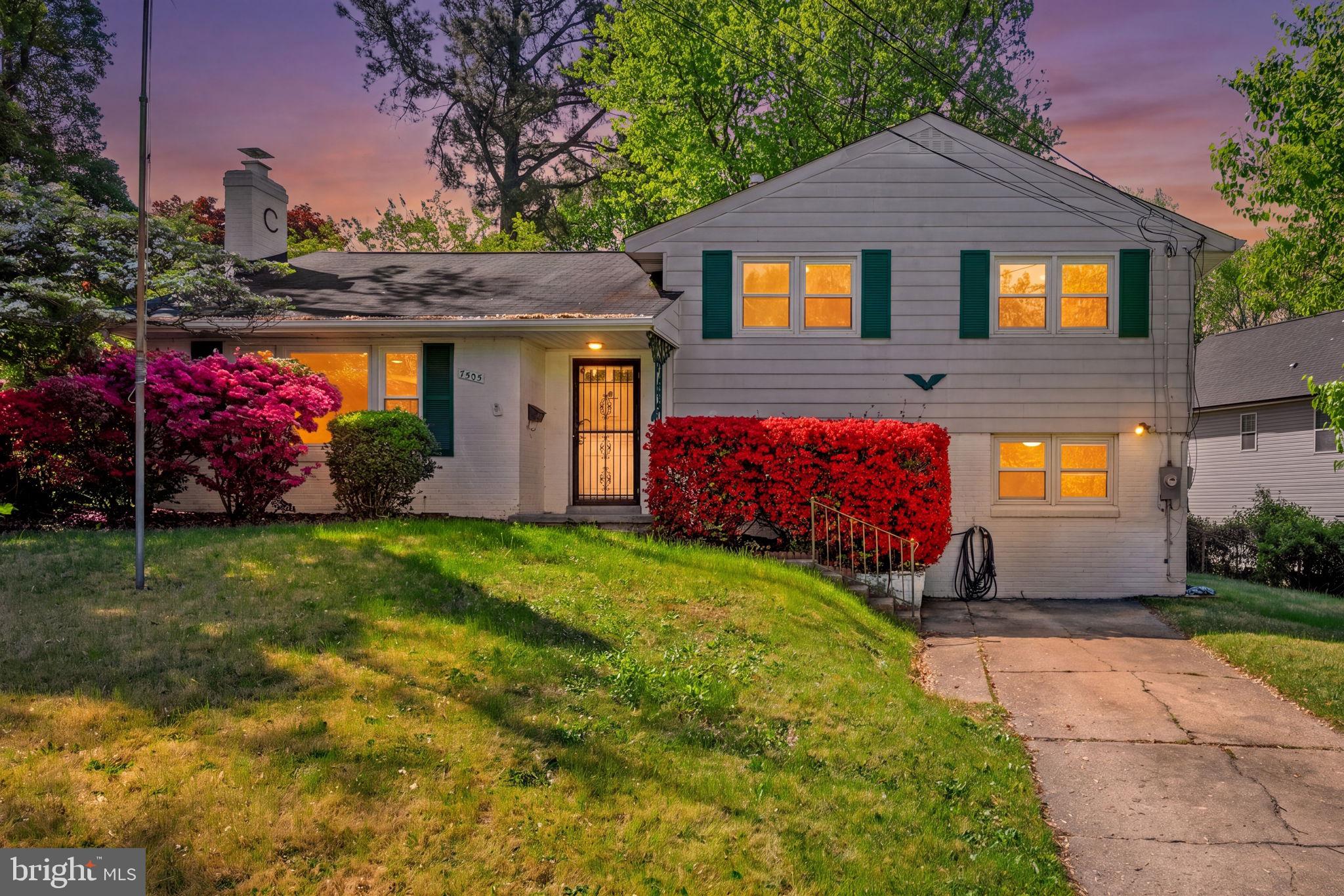 Charming home with vibrant landscaping.