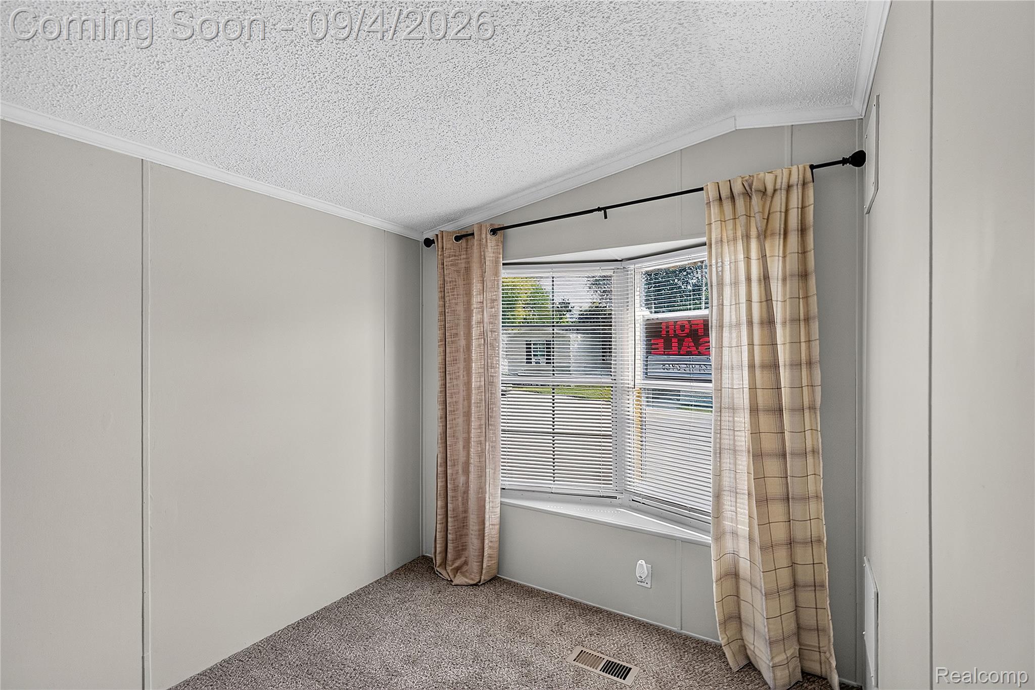 51074 Mott Road, Unit 200 Canton, MI 48188 - Photo 16 of 24 Bay window with integrated blinds, textured ceiling, light gray panel walls, and carpet flooring