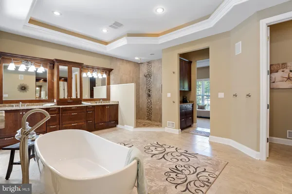 a spacious bedroom with a bed and a chandelier