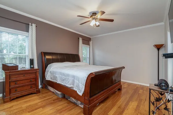 a bedroom with a bed and a chandelier