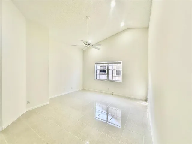 a large white kitchen with granite countertop a sink