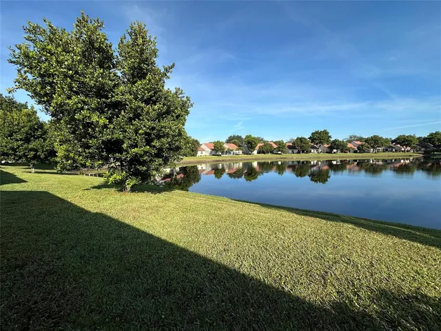 a view of a lake with a table and chairs