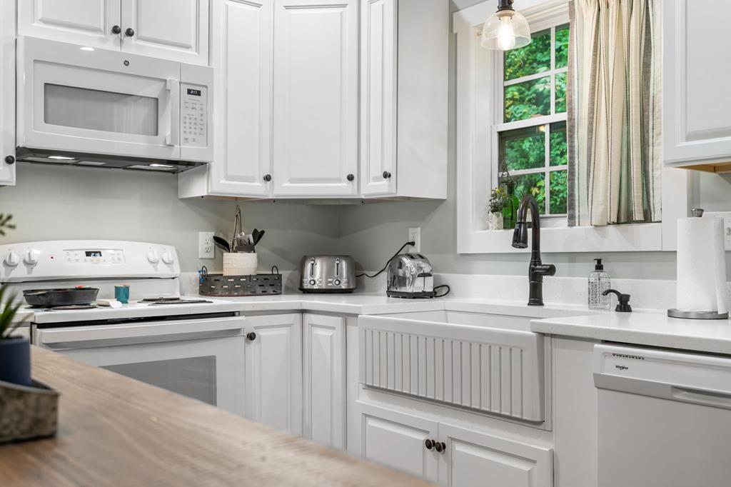 270 Hiawassee River Road Murphy, NC 28906 - Photo 11 of 50 a kitchen with stainless steel appliances granite countertop a sink a stove and cabinets