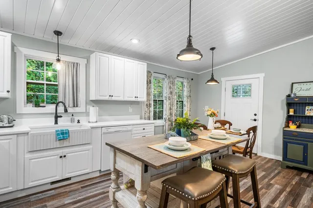 a kitchen with a table chairs stove and microwave