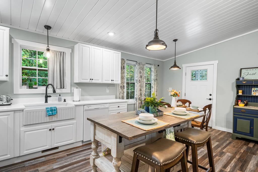 270 Hiawassee River Road Murphy, NC 28906 - Photo 15 of 50 a kitchen with a table chairs stove and microwave