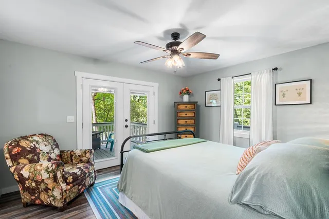a bedroom with a large bed and a chandelier