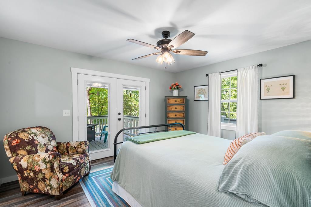 270 Hiawassee River Road Murphy, NC 28906 - Photo 18 of 50 a bedroom with a large bed and a chandelier