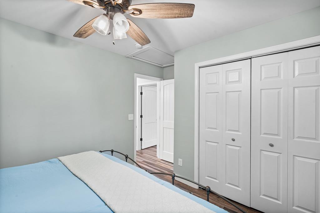 270 Hiawassee River Road Murphy, NC 28906 - Photo 21 of 50 a bedroom with a bed and a chandelier fan
