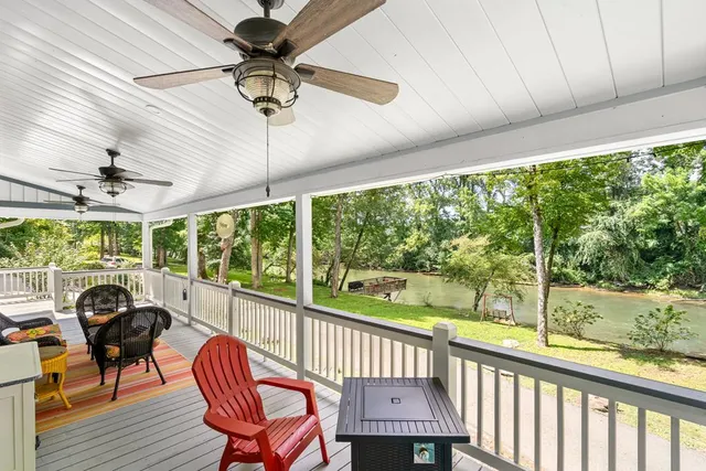 a view of a porch with furniture and a yard
