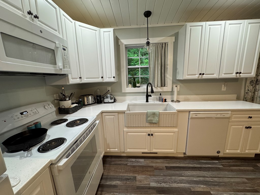 270 Hiawassee River Road Murphy, NC 28906 - Photo 3 of 50 a kitchen with white cabinets and white appliances