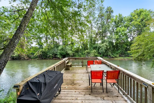 a view of a wooden deck and a garden