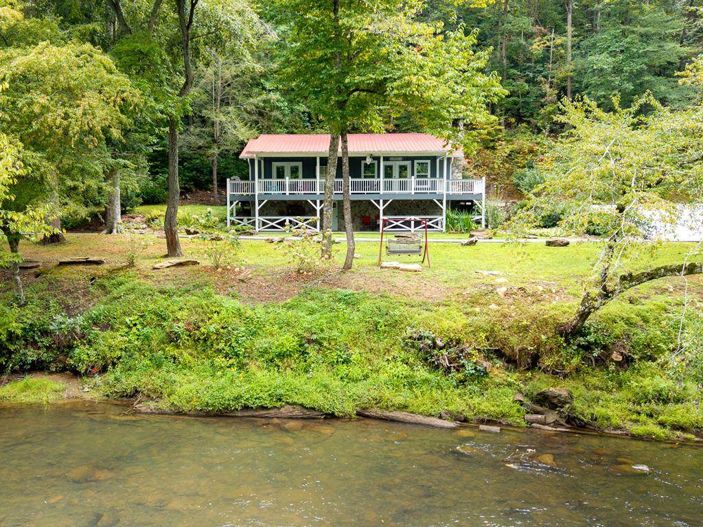 270 Hiawassee River Road Murphy, NC 28906 - Photo 37 of 50 a view of a swimming pool with lawn chairs and plants