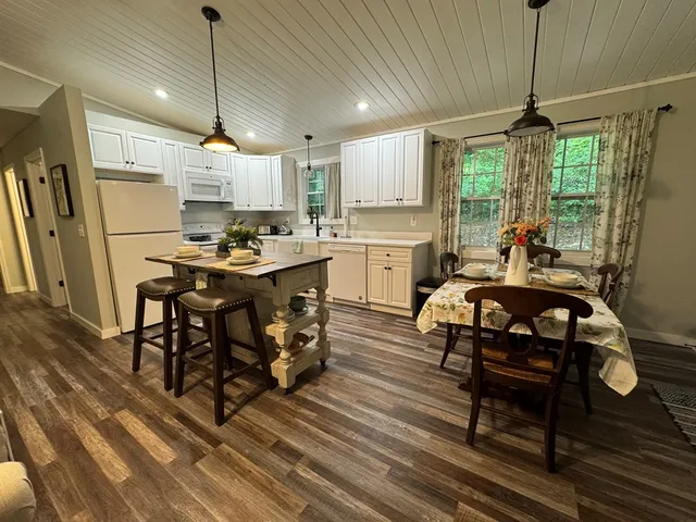 a kitchen that has a table chairs and a stove