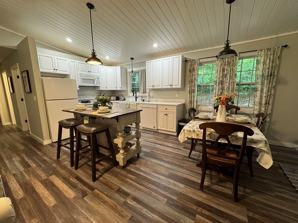 270 Hiawassee River Road Murphy, NC 28906 - Photo 4 of 50 a kitchen that has a table chairs and a stove
