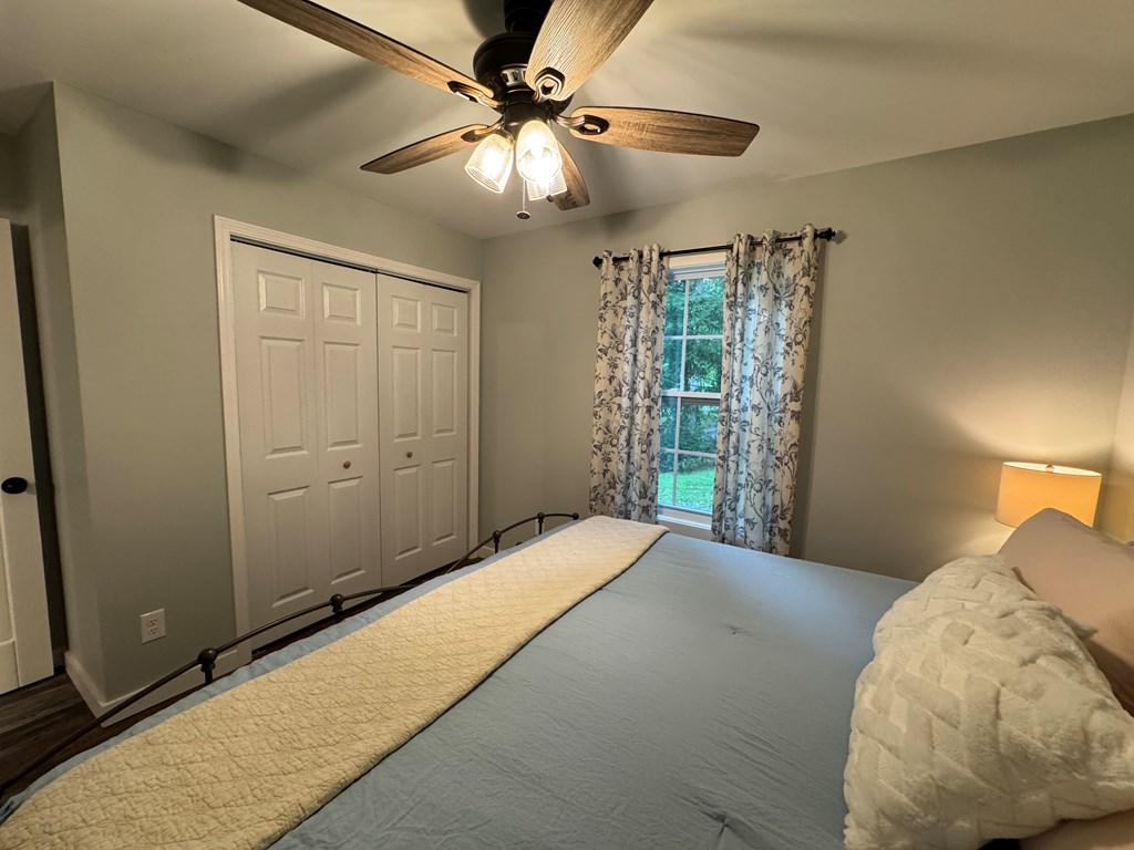 270 Hiawassee River Road Murphy, NC 28906 - Photo 7 of 50 a bedroom with a large bed and a chandelier