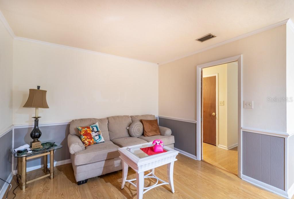 126 Southwest 40 Terrace Gainesville, FL 32607 - Photo 13 of 21 a living room with furniture and a wooden floor
