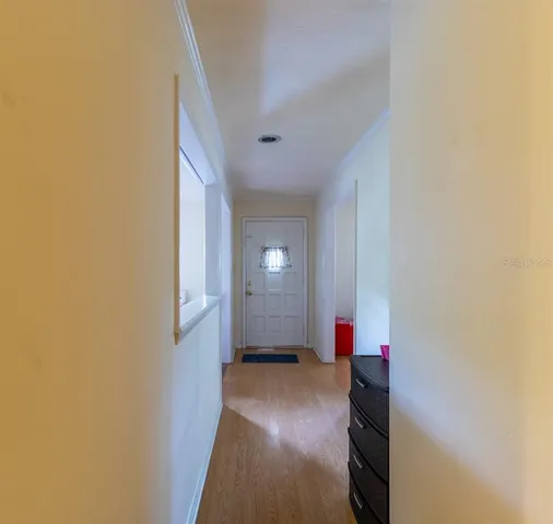 a view of a room with wooden floor and a window