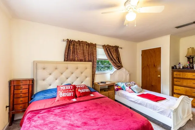 a bedroom with bed and a flat tv screen