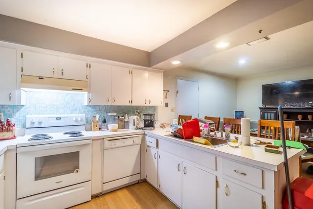 a kitchen with granite countertop a sink stainless steel appliances and cabinets