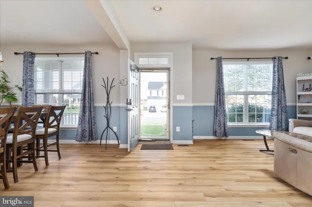a view of a livingroom with furniture window and wooden floor