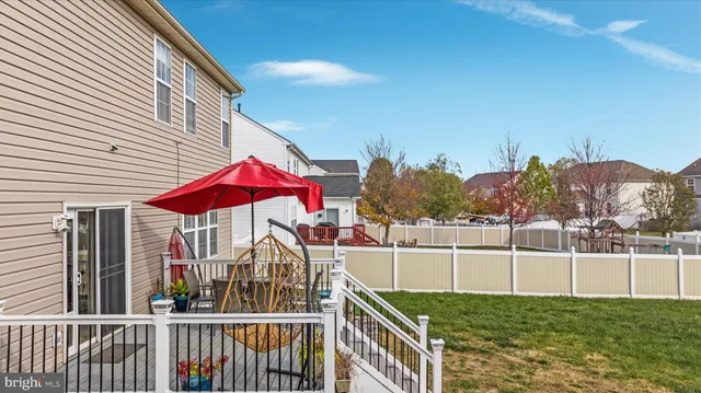 a view of backyard with swimming pool and outdoor seating