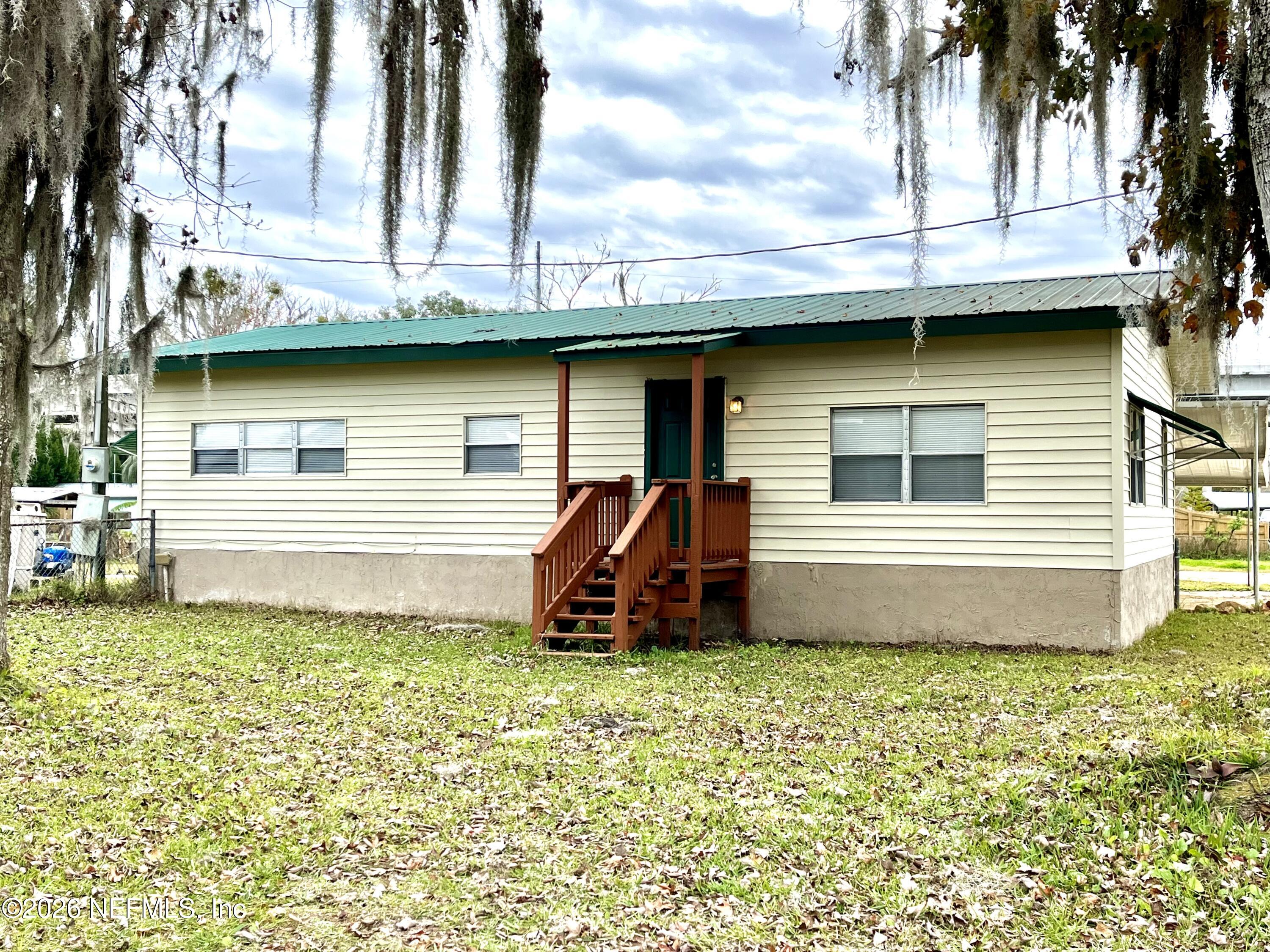145 Magnolia Trail Satsuma, FL 32189 - Photo 1 of 20 a front view of a house with garden