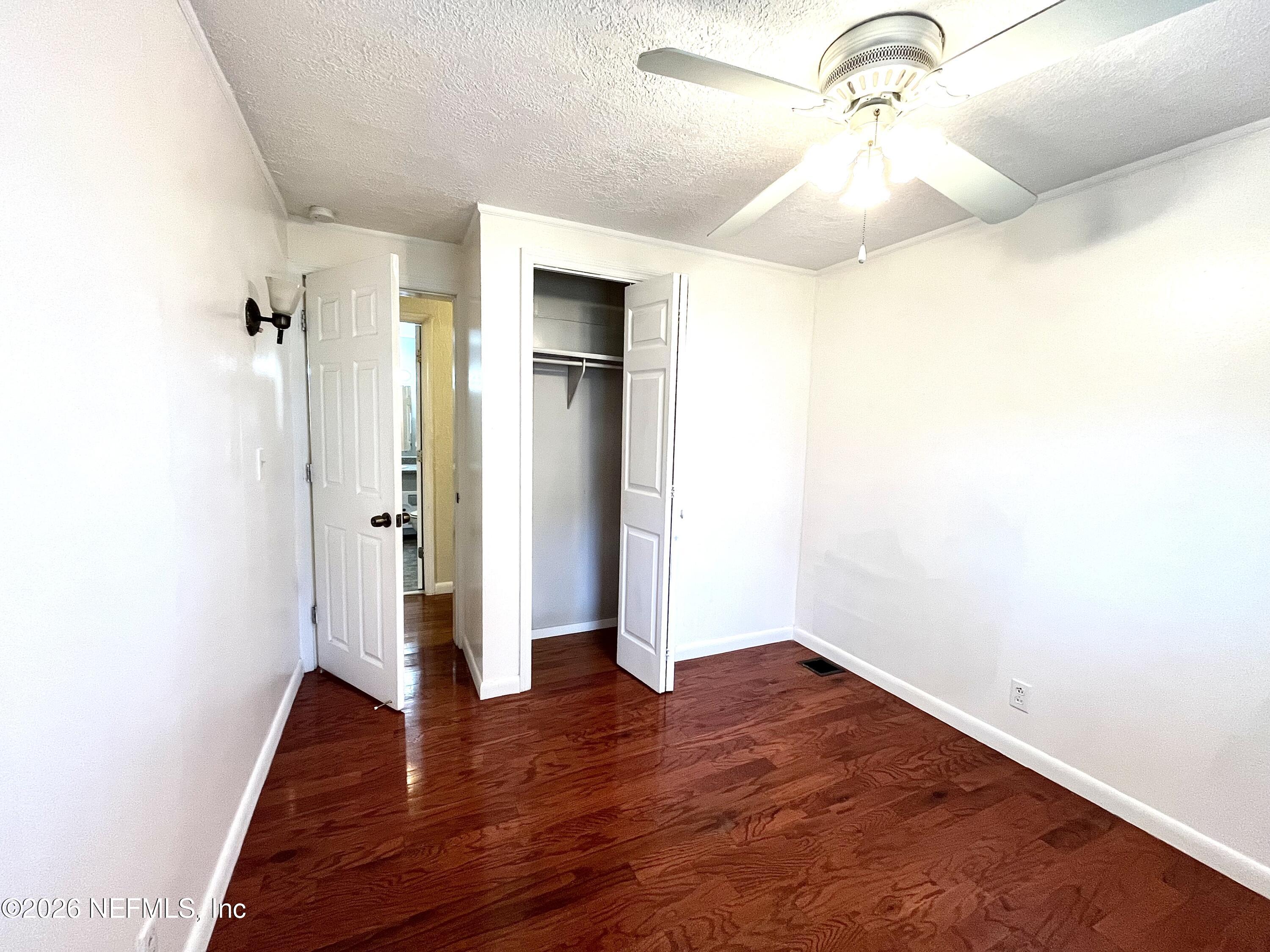 145 Magnolia Trail Satsuma, FL 32189 - Photo 14 of 20 a view of empty room with wooden floor