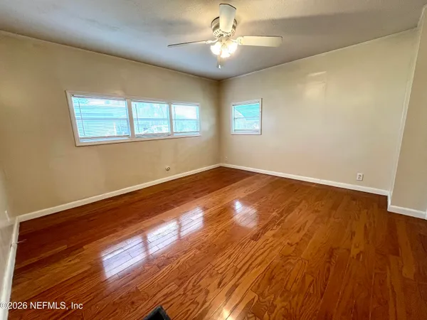 wooden floor in an empty room with a window