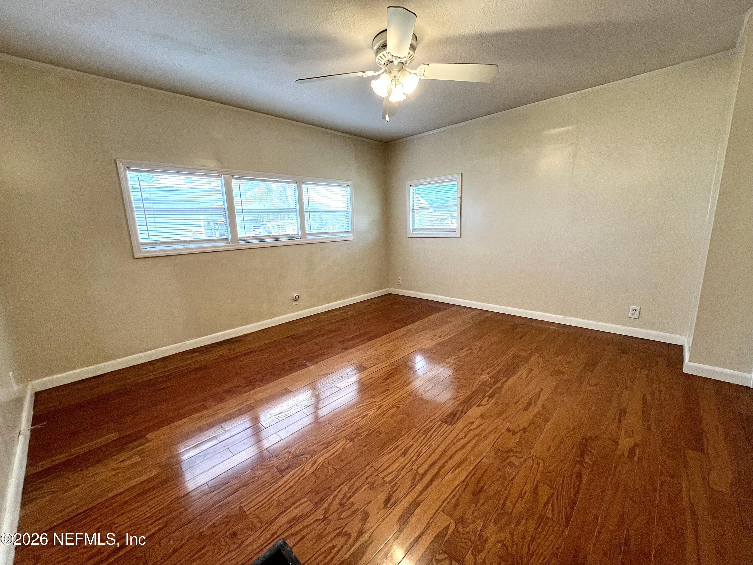 145 Magnolia Trail Satsuma, FL 32189 - Photo 17 of 20 a view of empty room with wooden floor and fan