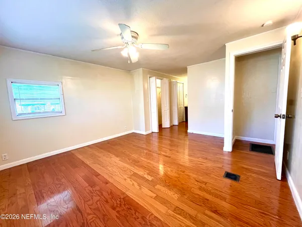 a view of a hallway with wooden floor