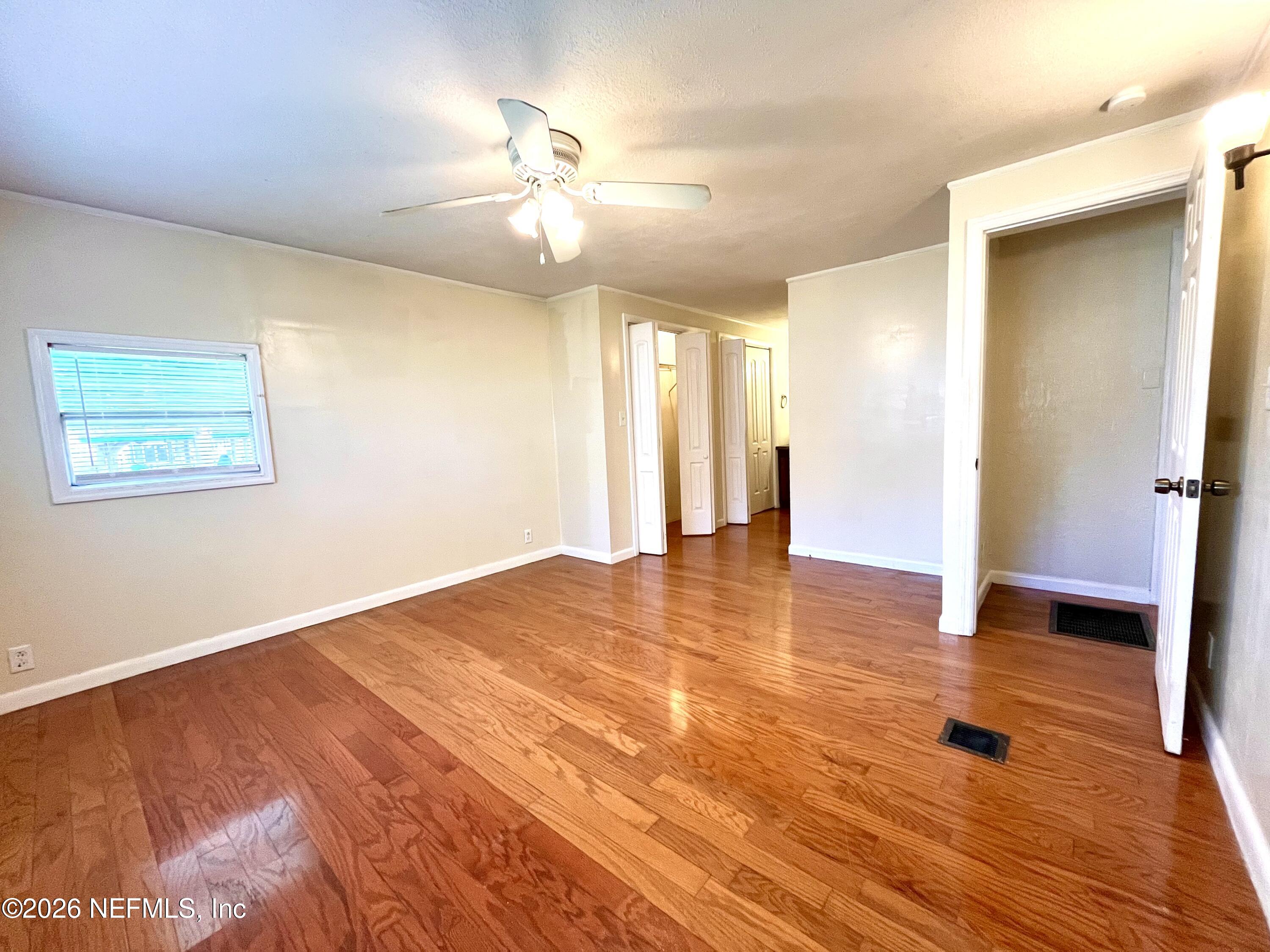 145 Magnolia Trail Satsuma, FL 32189 - Photo 18 of 20 wooden floor in an empty room with a window