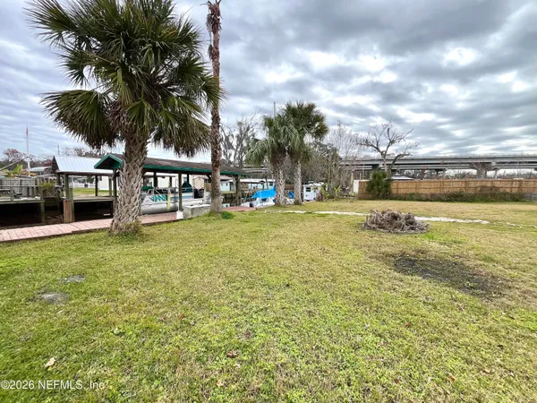 a swimming pool with outdoor seating and yard