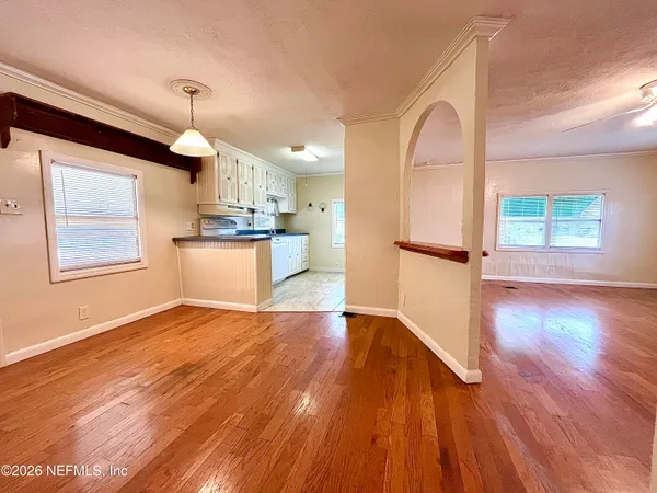 a kitchen with stainless steel appliances granite countertop a refrigerator a stove and a wooden floors