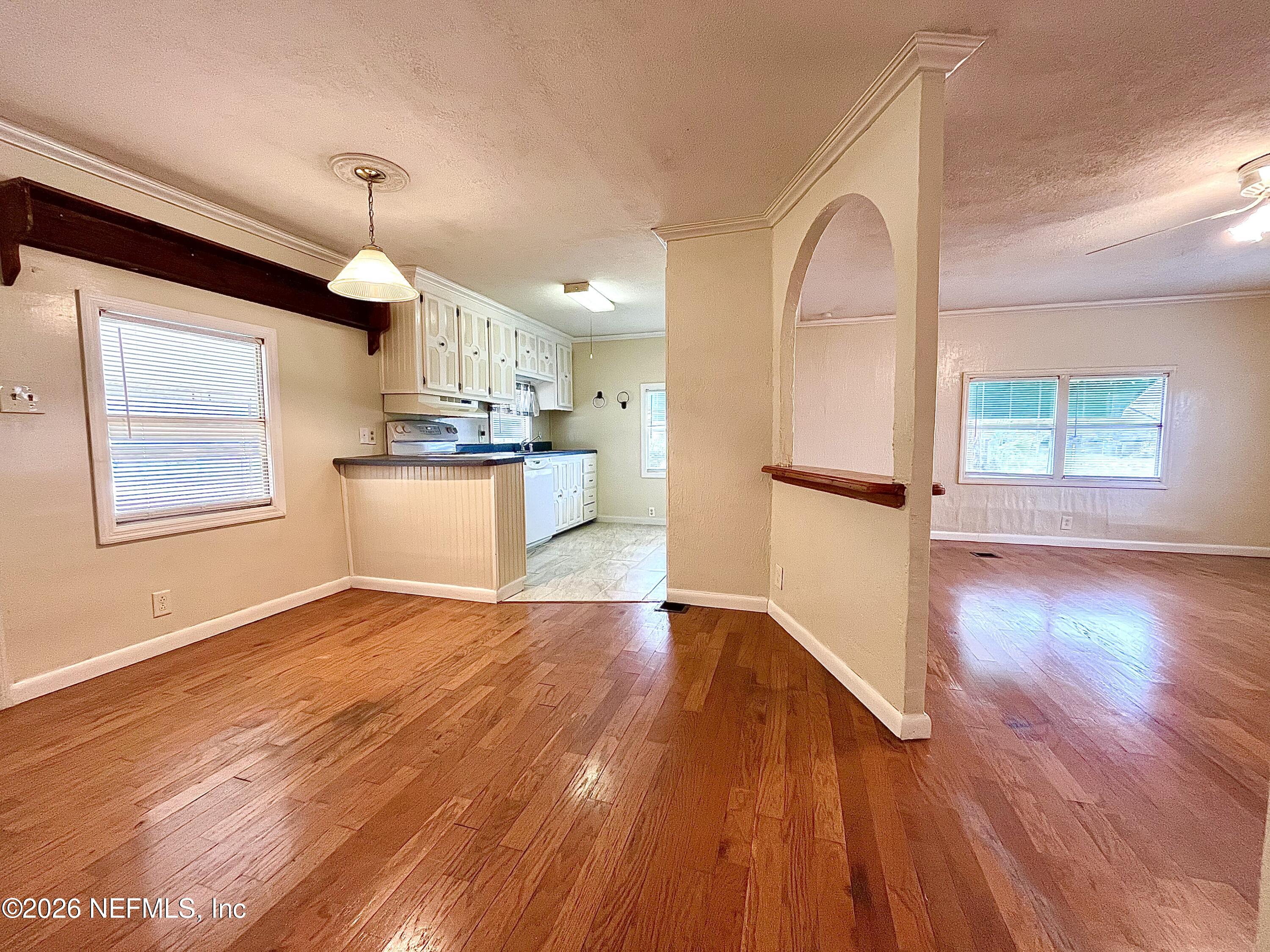 145 Magnolia Trail Satsuma, FL 32189 - Photo 8 of 20 a view of a kitchen with wooden floor and a kitchen