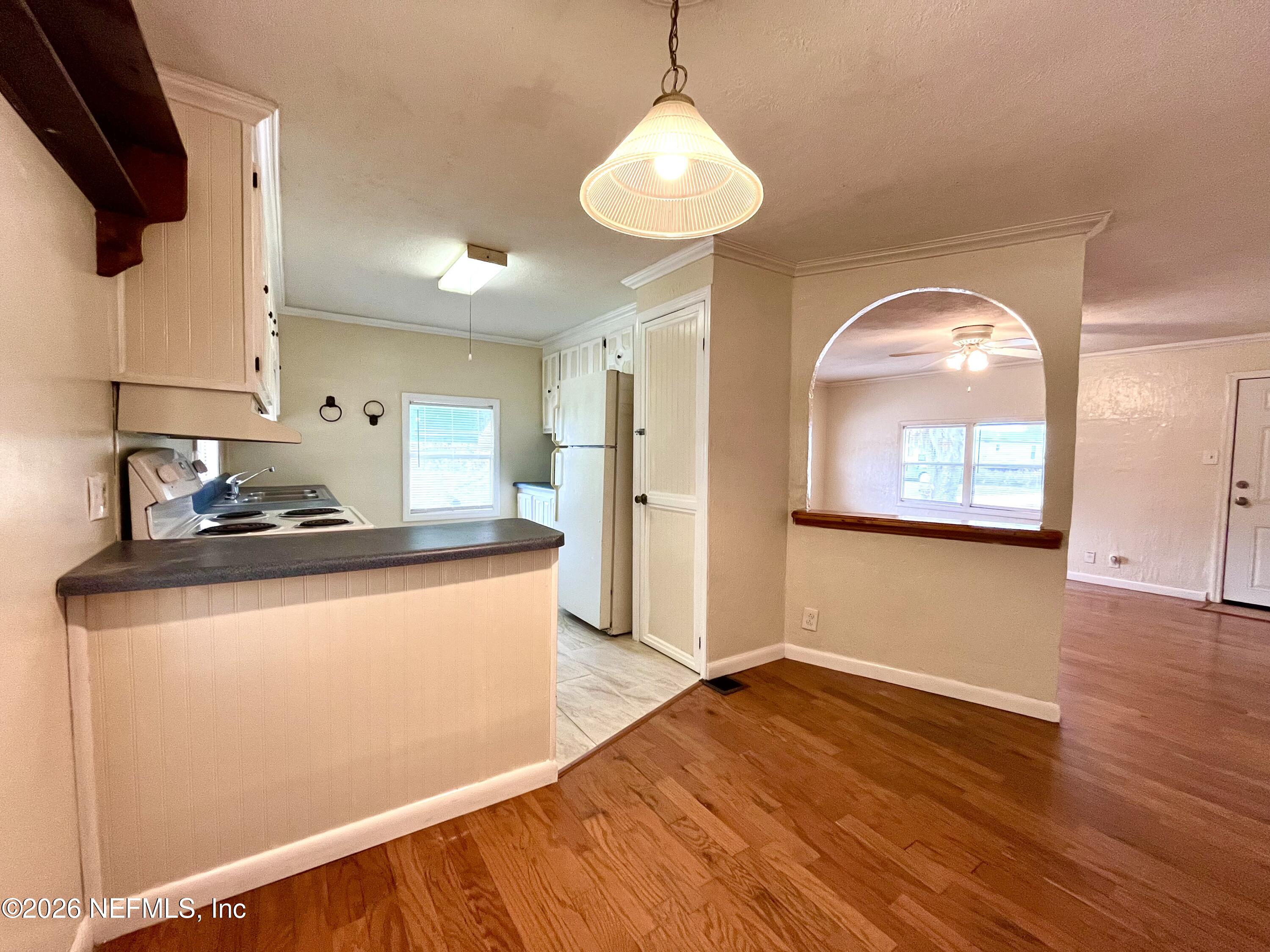 145 Magnolia Trail Satsuma, FL 32189 - Photo 9 of 20 a kitchen with stainless steel appliances granite countertop a refrigerator a stove and a wooden floors
