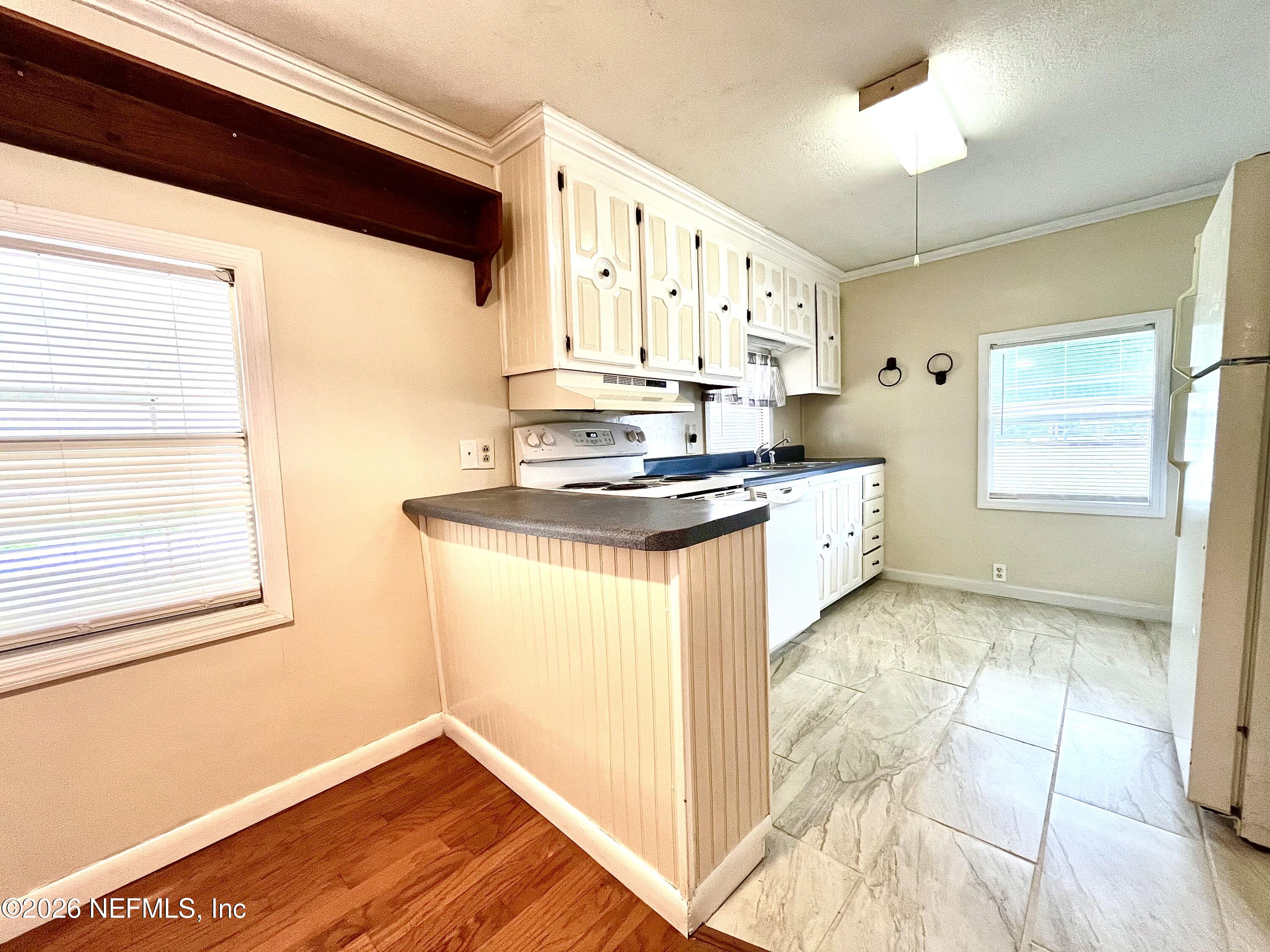 145 Magnolia Trail Satsuma, FL 32189 - Photo 10 of 20 a kitchen with stainless steel appliances granite countertop a sink stove and cabinets