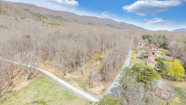 a view of a dry yard with mountains in the background