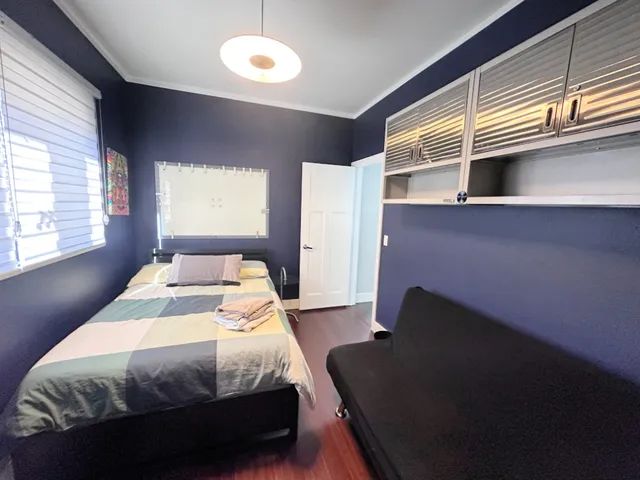 a bedroom with a bed and a window