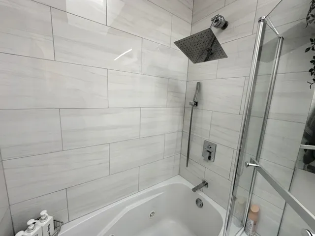 a bathroom with a bathtub and shower